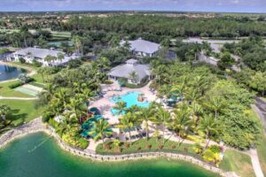 Aerial view of a Naples golf resort community with a lagoon-style pool