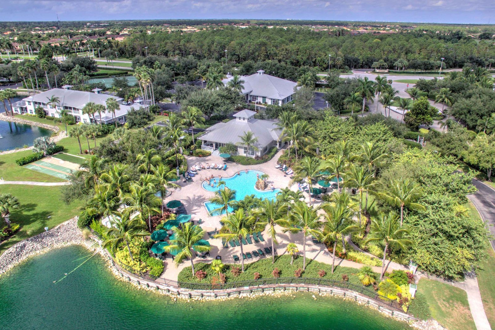 Aerial view of a Naples golf resort community with a lagoon-style pool