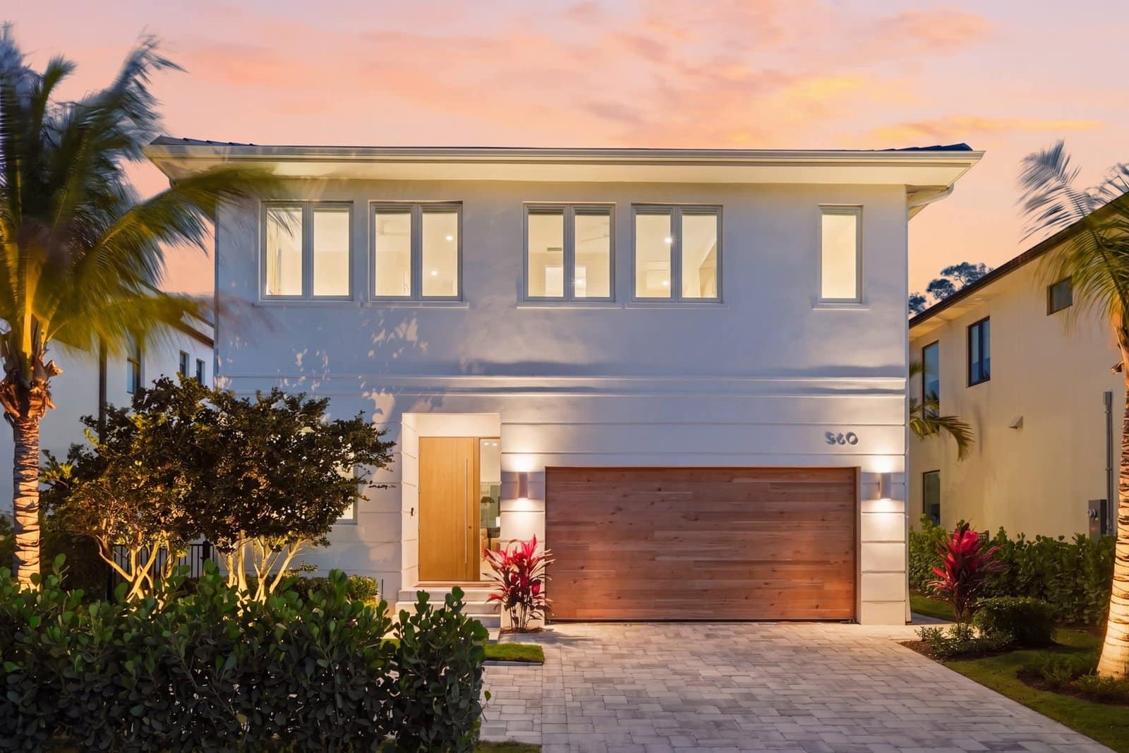 Modern two-story vacation home exterior at twilight in Naples, FL